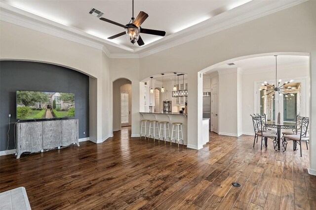 2413 Never Bend Cv, Austin, TX 78746 - living area with dark wood-style flooring, a chandelier, crown molding, a ceiling fan, and baseboards