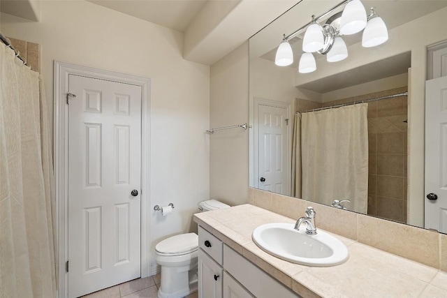 bathroom featuring toilet, a shower with shower curtain, vanity, and tile patterned floors