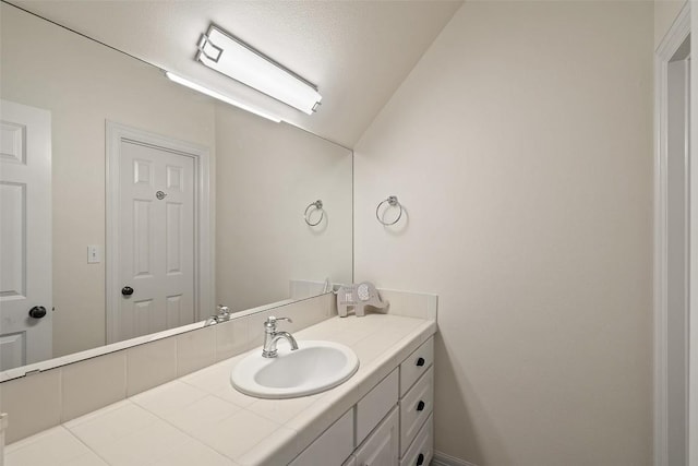 bathroom featuring lofted ceiling and vanity