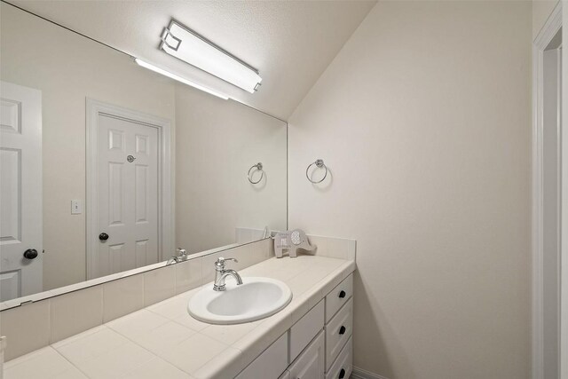 2413 Never Bend Cv, Austin, TX 78746 - bathroom featuring vanity and lofted ceiling
