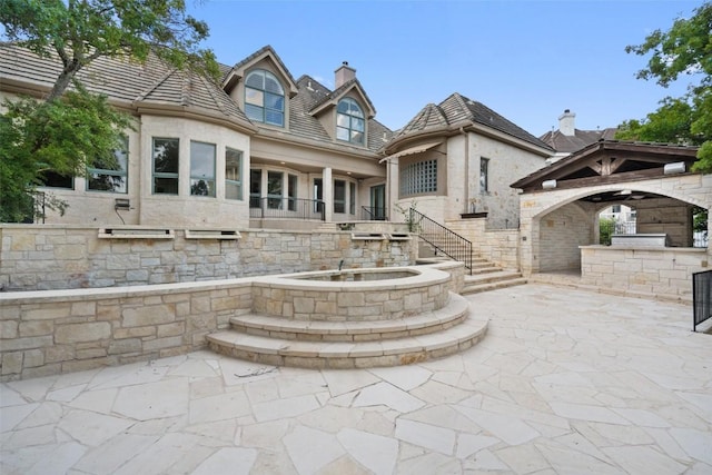 2413 Never Bend Cv, Austin, TX 78746 - back of property with a chimney, a patio, area for grilling, stairs, and a gazebo