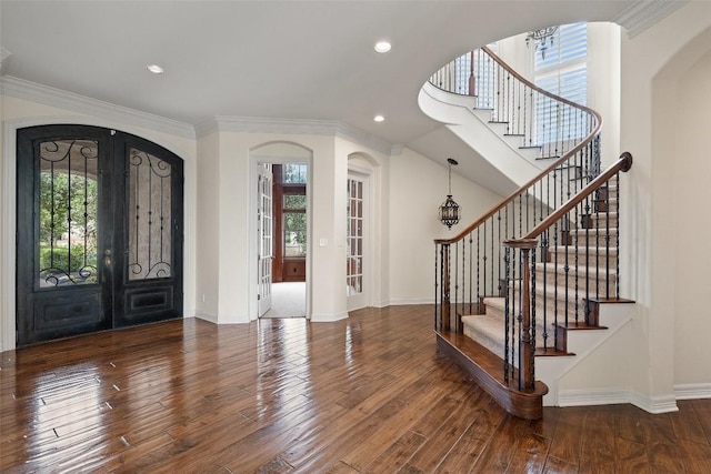 foyer featuring french doors, recessed lighting, wood-type flooring, ornamental molding, and baseboards