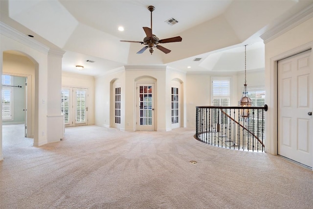 empty room featuring a healthy amount of sunlight, light carpet, and crown molding