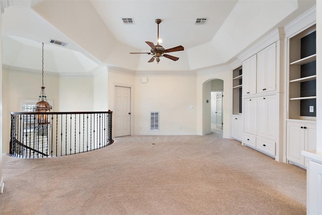 unfurnished room with light carpet, a raised ceiling, and visible vents