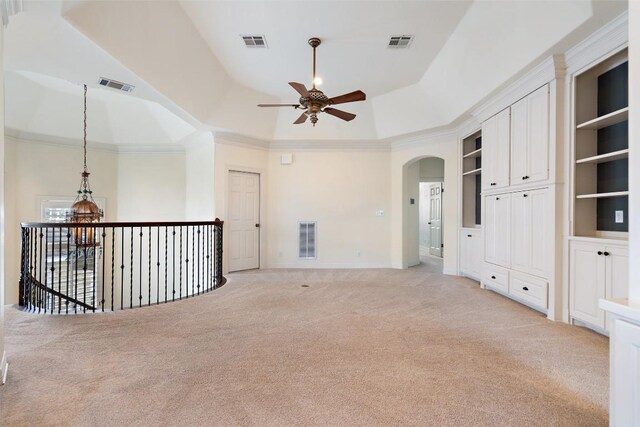 2413 Never Bend Cv, Austin, TX 78746 - unfurnished room with ceiling fan, light colored carpet, arched walkways, baseboards, and crown molding