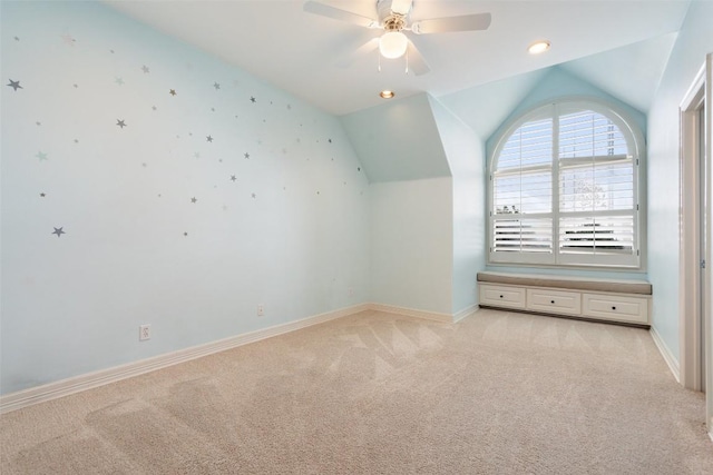 bonus room with light colored carpet, vaulted ceiling, and baseboards