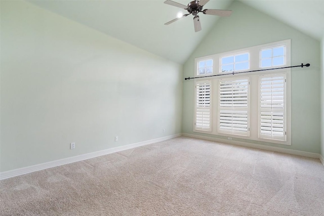 unfurnished room with carpet floors, ceiling fan, high vaulted ceiling, and baseboards