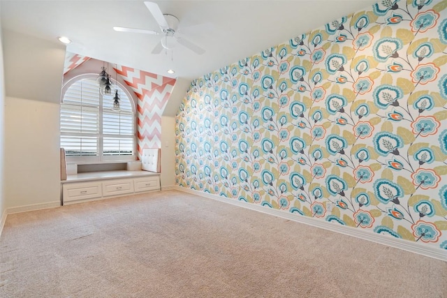 unfurnished room with wallpapered walls, a ceiling fan, baseboards, and carpet flooring