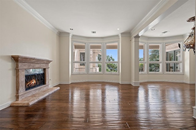 unfurnished living room with dark wood-style flooring, a fireplace, visible vents, baseboards, and crown molding