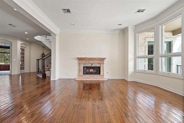 2413 Never Bend Cv, Austin, TX 78746 - unfurnished living room featuring stairway, wood-type flooring, a fireplace, ornamental molding, and baseboards