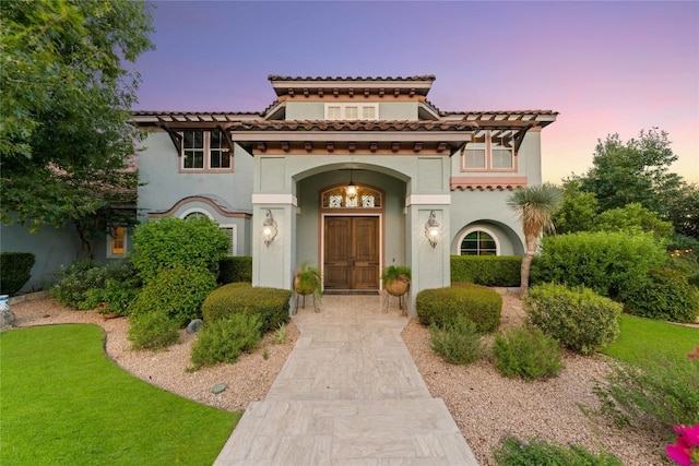 view of front of property with a front lawn and stucco siding