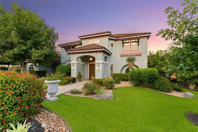 mediterranean / spanish-style home featuring a lawn