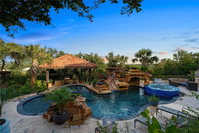 view of swimming pool featuring an in ground hot tub, a gazebo, a patio, and an outdoor hangout area