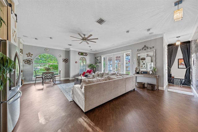 living room featuring a wealth of natural light, crown molding, and dark hardwood / wood-style floors