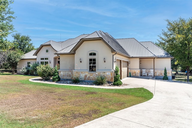 view of front of property with a front yard and a garage