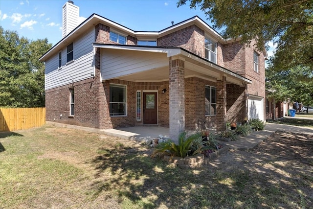 rear view of house featuring a lawn