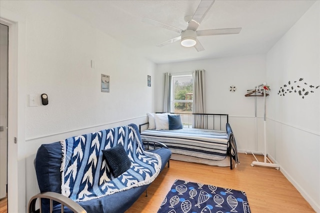 living area featuring ceiling fan and hardwood / wood-style flooring