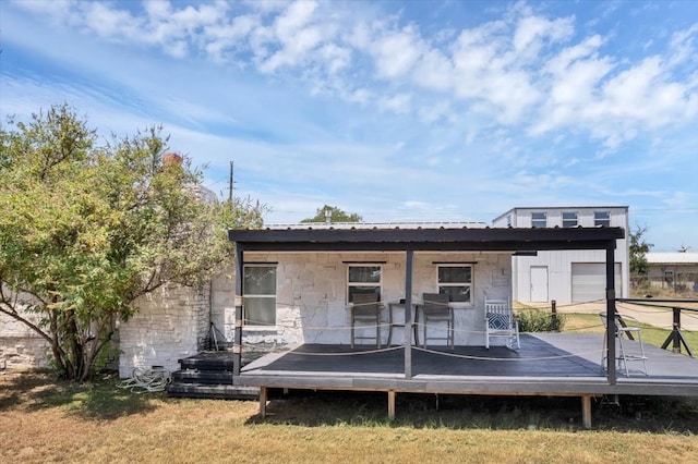 back of house featuring a deck