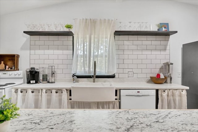 kitchen featuring sink, white appliances, and lofted ceiling