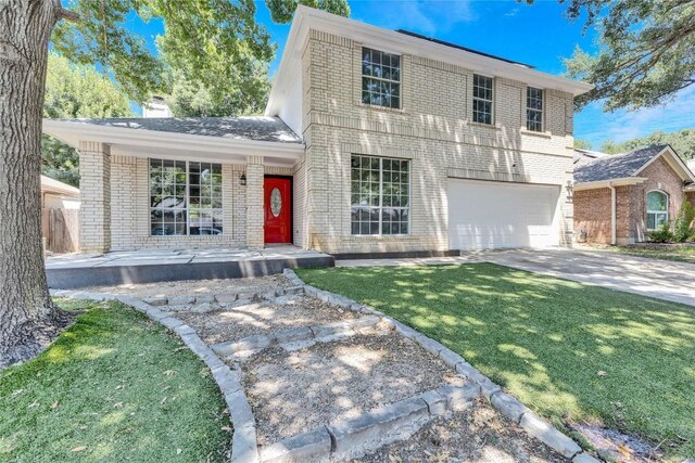 view of front of home featuring a garage and a front yard