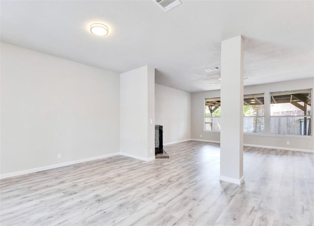 interior space featuring light wood finished floors, visible vents, and baseboards