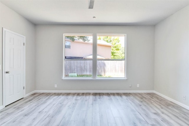 unfurnished room featuring light wood-type flooring and baseboards