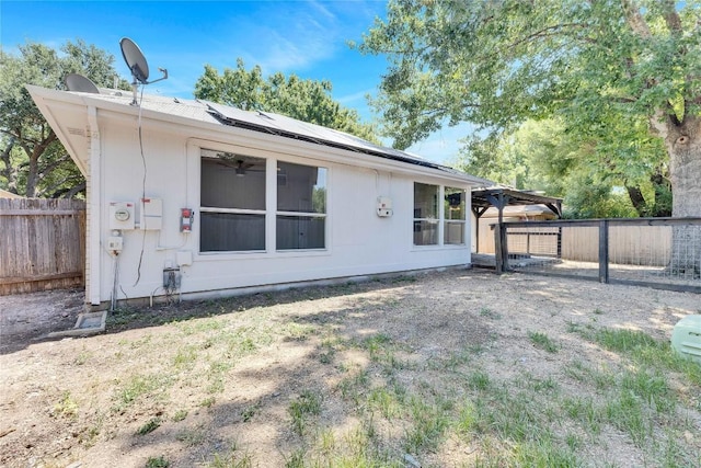 back of house with fence