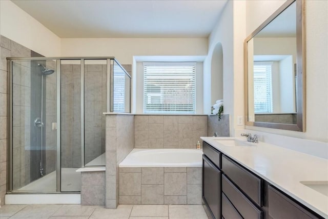 full bath featuring double vanity, a sink, a bath, and a shower stall