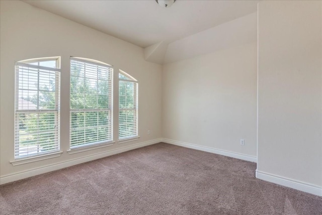 empty room with carpet floors and baseboards