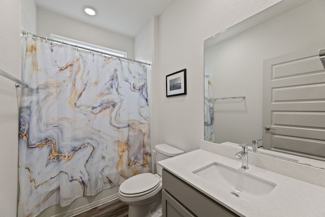 full bathroom featuring wood-type flooring, toilet, vanity, and shower / bath combo