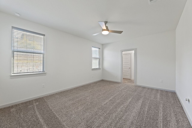 empty room featuring carpet floors and ceiling fan