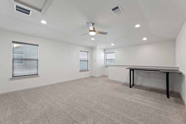 carpeted spare room with ceiling fan