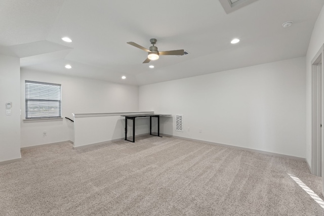 empty room with ceiling fan and light carpet