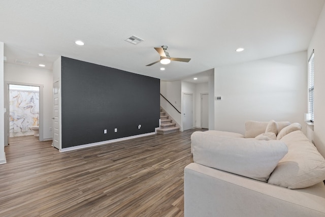 living room with ceiling fan and wood-type flooring