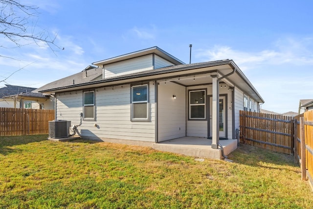 back of property featuring a lawn, a patio, and central air condition unit