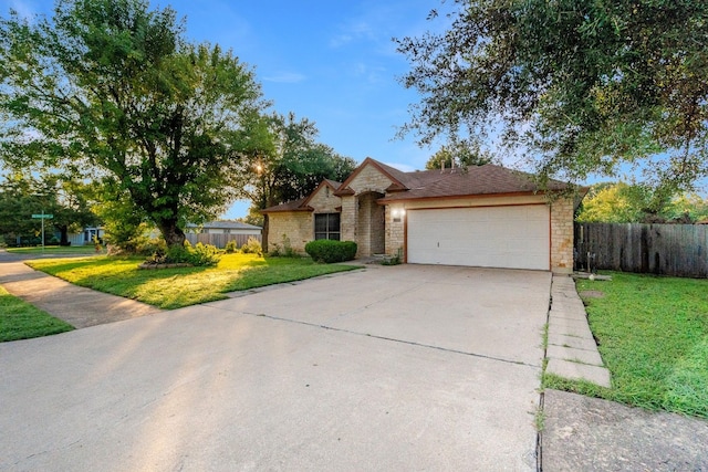 ranch-style house featuring a garage and a front lawn