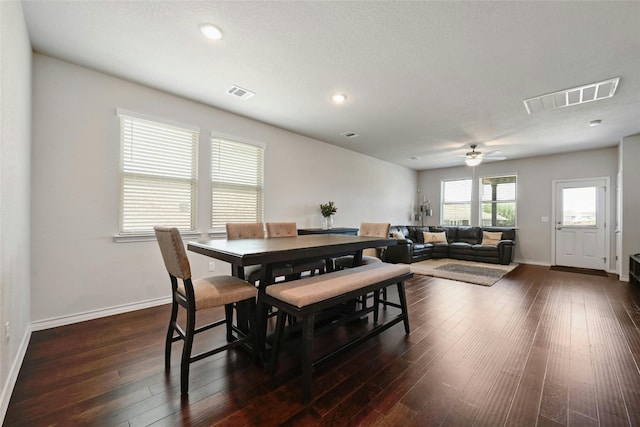 dining space with ceiling fan and dark hardwood / wood-style flooring