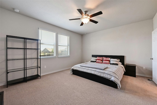 bedroom featuring ceiling fan and light carpet