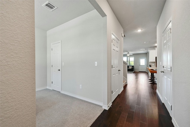 corridor with hardwood / wood-style flooring