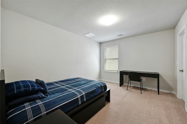 carpeted bedroom with a textured ceiling