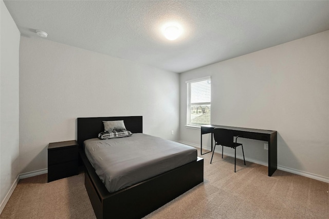 carpeted bedroom with a textured ceiling