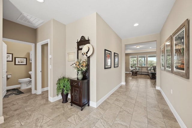 hallway featuring recessed lighting, marble finish floor, visible vents, and baseboards