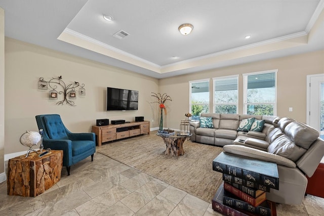 living area with a raised ceiling, visible vents, and crown molding