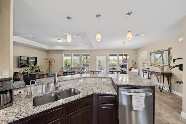 kitchen with dishwasher, dark brown cabinets, sink, pendant lighting, and a tray ceiling