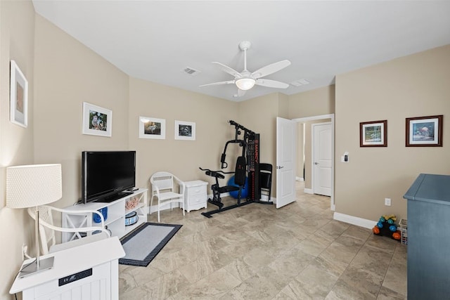 workout area featuring ceiling fan and light tile patterned floors