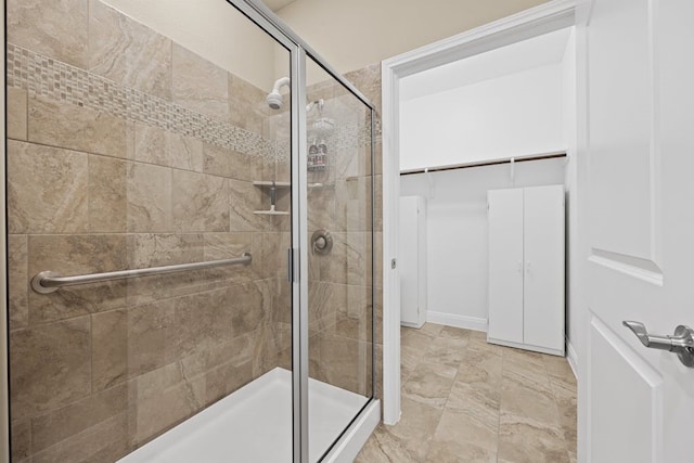 bathroom with tile patterned flooring and walk in shower