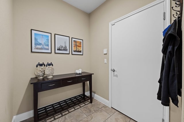 foyer with baseboards and light tile patterned floors