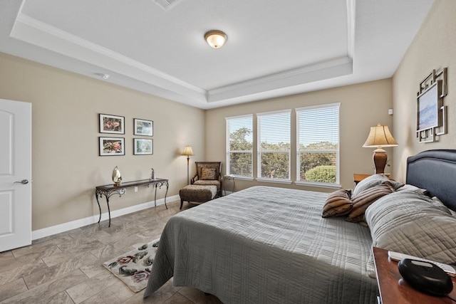 tiled bedroom featuring a raised ceiling