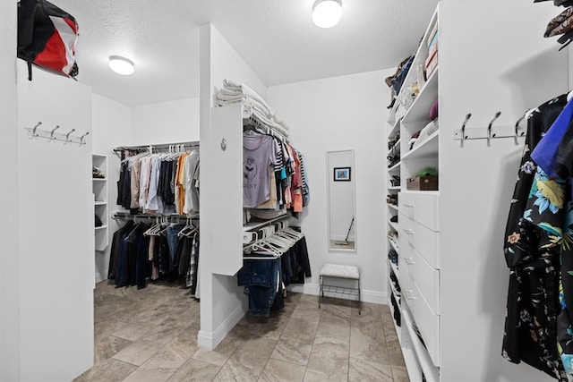 spacious closet with light tile patterned floors