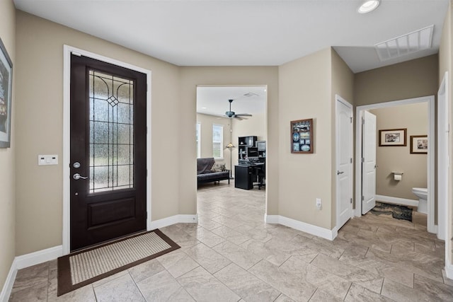 tiled entrance foyer featuring ceiling fan